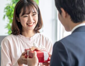 彼氏にプレゼントを渡す女性