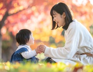赤ちゃんと公園で遊ぶ母親